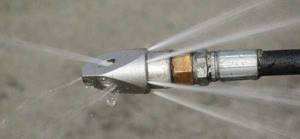 There is a special nozzle that creates narrow, strong jets that break up even years of accumulation.
