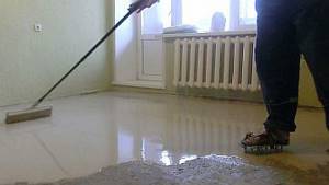 Photo - Pouring a self-leveling solution over an infrared floor