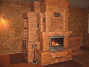 Massive brick stove with several fireboxes and shelves