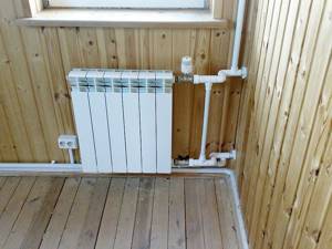 Installing a radiator on a wooden wall.