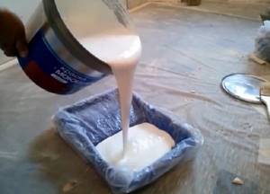 pour paint into the roller container