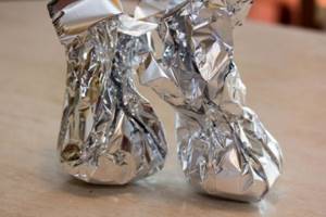 food is wrapped in foil pouches before baking in the oven