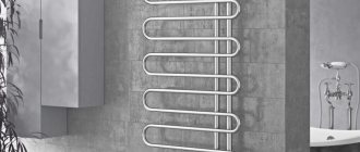 Heated towel rail with protection against stray currents