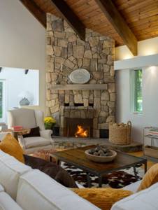 Corner fireplace in country style in the interior of a country house living room