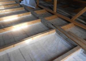 We start insulating the attic floor with a vapor barrier