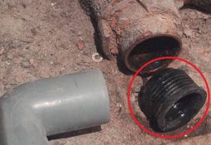 Replacing a cast iron sewer riser with a plastic one using a special rubber adapter