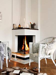 Sitting area near the elegantly designed plastered corner fireplace